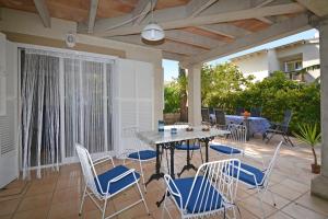 a patio with a table and chairs on a patio at Salada House in Port d'Alcudia