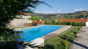 a swimming pool in the yard of a house at Quinta Do Acipreste (Antiga Quinta Da Torre) in Lamego