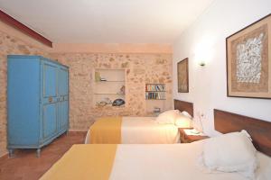 a bedroom with two beds and a blue cabinet at Villa Torreon in Alcudia