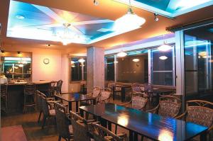 a dining room with tables and chairs in a restaurant at Hakodate Motomachi Hotel in Hakodate