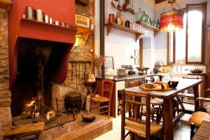 a kitchen with a fireplace and a table in front of it at Casa Leonardo in Senterada