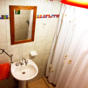 a bathroom with a sink and a mirror at Cabañas de Campo in Santa María