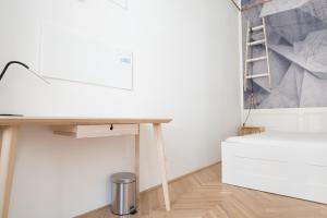 a desk in a room with a white wall at NICE "TRABI" APARTMENT IN THE CITY in Budapest