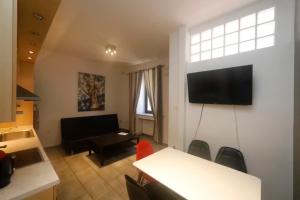 a living room with a flat screen tv on a wall at Gazi Boutique Apartment 1 in Athens