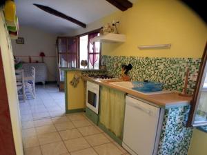 a kitchen with a sink and a stove top oven at Gite du Grand-Pas in Doulezon