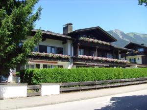a house with flowers on the front of it at Gästehaus Immenhof in Oberstdorf