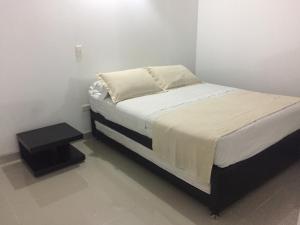 En eller flere senge i et værelse på Jardín Amoblados