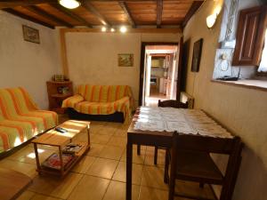 a living room with a couch and a table at Belvilla by OYO Conca oro in Marliana