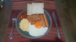 a plate of breakfast food with eggs beans and bread at Melina Beach Front Bungalows in Tha Lane Bay