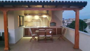 a kitchen with a table and chairs on a balcony at B&B e Casa Vacanza al Castello in Roccella Ionica