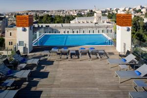 a group of lounge chairs and a swimming pool at St. George Hotel in Jerusalem +113 photos