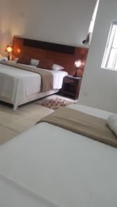 Llit o llits en una habitació de Giuseppe Suites Hotel