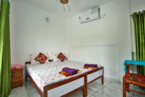 a bedroom with a bed with pillows on it at Aaron's Homestay in Cochin