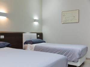 Postel nebo postele na pokoji v ubytování Venustas Roma Hotel