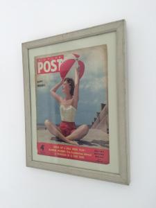 a framed picture of a woman holding an umbrella at The Garage in Banbury