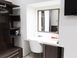 a bathroom with a white sink and a mirror at Venustas Roma Hotel in Rome