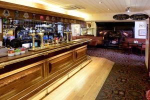 a bar in a pub with a counter and a bar at Stags Head Hotel in Bowness-on-Windermere
