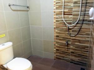a bathroom with a shower with a toilet at Go Green Resort in Chumphon