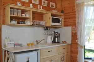a kitchen with a sink and a microwave at Meshi Belavan in Metulla +4 photos