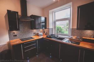 a kitchen with a counter and a sink and a window at Stylish and Spacious two bed in Aberdeen's West End in Aberdeen