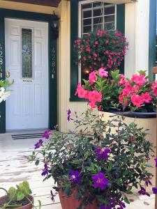 a porch with flowers in front of a door at Ellis House Bed & Breakfast in Niagara Falls