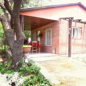 a brick house with a tree in front of it at Cabañas de Campo in Santa María