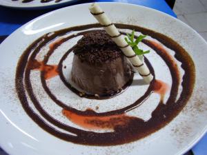 un postre de chocolate en un plato blanco con salsa marrón en Miami Motel ( ADULT ONLY ), en Pindamonhangaba