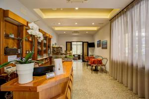 a living room with a counter and a dining room at Hotel Villa dei Gerani in Rimini