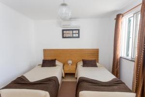 Postel nebo postele na pokoji v ubytování Apartamentos Oliveira