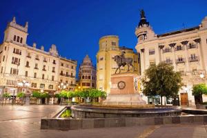 a statue in the middle of a city with buildings at Eduardo Lucena 5, Flamenco in Córdoba