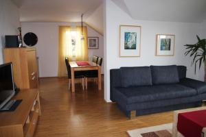 a living room with a couch and a table at Haus Köberle Ummendorf in Ummendorf-Biberach