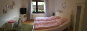 a bedroom with a bed and a television at Köln Appartement in Cologne