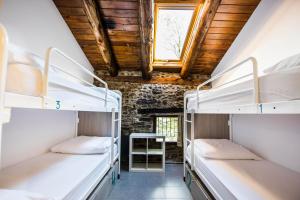 Ένα ή περισσότερα κρεβάτια σε δωμάτιο στο Mountain Hostel Tarter