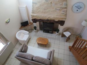 a living room with a couch and a fireplace at Gîte Carpe Diem in Quimperlé