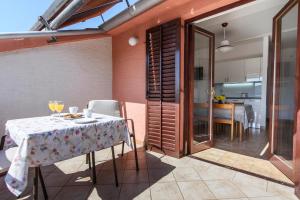 ein Esszimmer mit einem Tisch und einer Küche in der Unterkunft Apartments Martina in Primošten