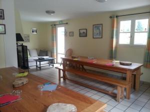 a living room with a table and a couch at Gîte de montagne du Plateau de Lhers in Accous