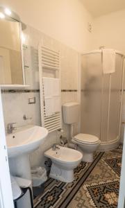a bathroom with a sink and a toilet and a shower at Camere Fontanavecchia in Vernazza