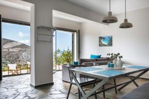 a living room with a table and a couch at Myrtos View Apartments in Anomeriá