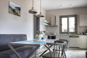 a kitchen and dining room with a table and chairs at Myrtos View Apartments in Anomeriá
