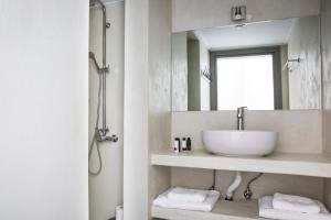 a bathroom with a sink and a mirror at Myrtos View Apartments in Anomeriá