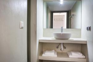 a bathroom with a sink and a mirror at Myrtos View Apartments in Anomeriá +27 photos