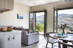 a living room with a couch and a table at Myrtos View Apartments in Anomeriá