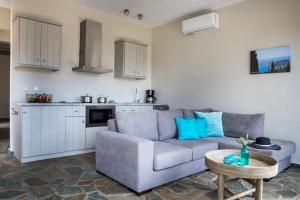a living room with a couch and a table at Myrtos View Apartments in Anomeriá