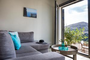 a living room with a couch and a table at Myrtos View Apartments in Anomeriá