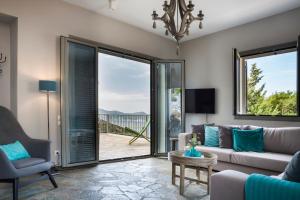 a living room with a couch and a table at Myrtos View Apartments in Anomeriá