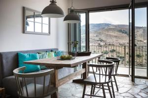 a dining room with a table and chairs with a view at Myrtos View Apartments in Anomeriá