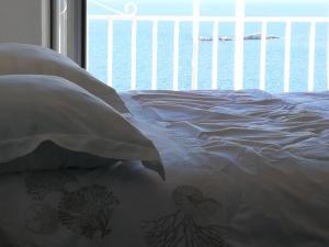 a bedroom with a bed with a view of the ocean at Apartments Joy in Cavtat