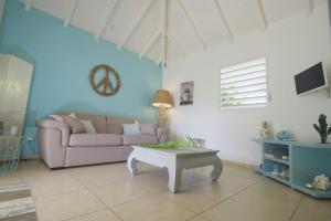 a living room with a couch and a coffee table at La petite kaz in Saint-François