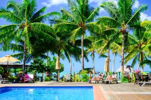 a resort with palm trees and a swimming pool at Le Vasa Resort in Fuailalo