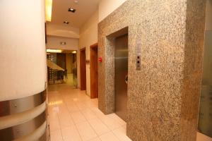 a hallway in a hospital with a tile wall at Hotel Flisvos in Kalamata